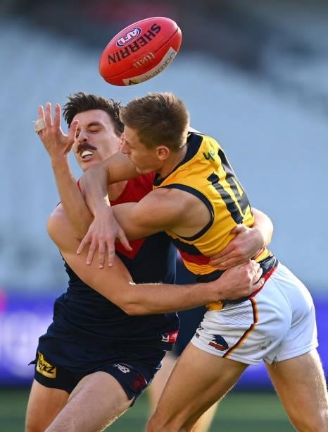 David Mackay of the Crows is tackled by Jake Lever of the Demons during the round 22 AFL match between Melbourne Demons and Adelaide Crows at...