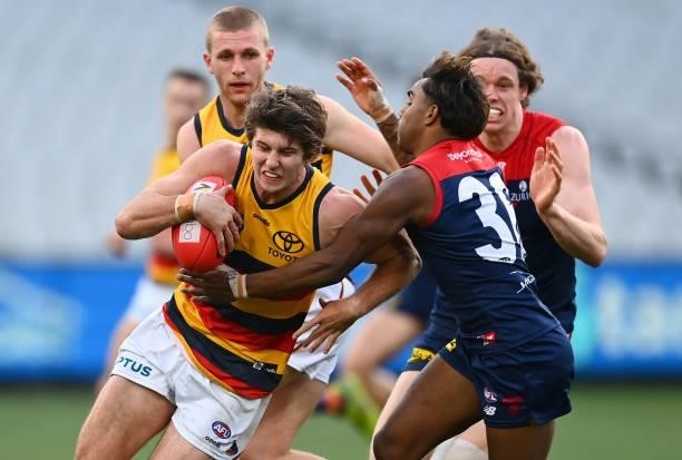 Jordon Butts of the Crows is tackled by Kysaiah Pickett of the Demons iduring the round 22 AFL match between Melbourne Demons and Adelaide Crows at...