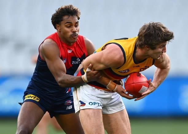 Jordon Butts of the Crows is tackled by Kysaiah Pickett of the Demons iduring the round 22 AFL match between Melbourne Demons and Adelaide Crows at...