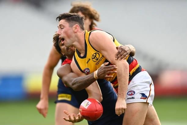 Chayce Jones of the Crows handballs whilst being tackled by Kysaiah Pickett of the Demons during the round 22 AFL match between Melbourne Demons and...