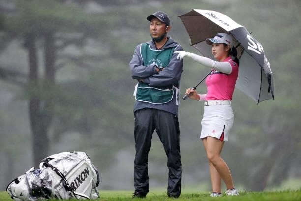 Sakura Koiwai of Japan talks with her caddie before her second shot on the 14th hole during the final round of the NEC Karuizawa 72 Golf Tournament...