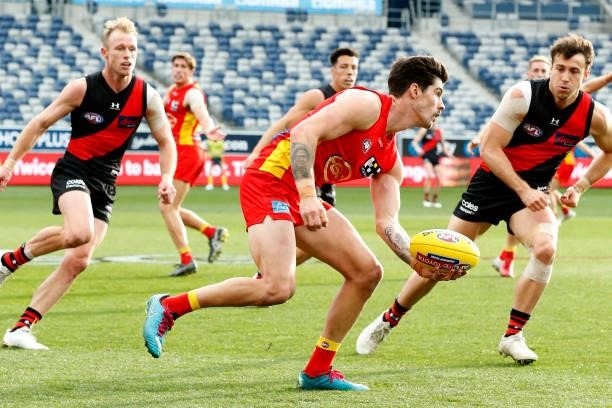 Alex Sexton of the Suns handballs during the round 22 AFL match between Gold Coast Suns and Essendon Bombers at GMHBA Stadium on August 15, 2021 in...