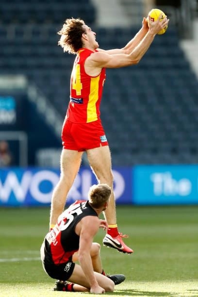 Ben King of the Suns marks the ball during the round 22 AFL match between Gold Coast Suns and Essendon Bombers at GMHBA Stadium on August 15, 2021 in...
