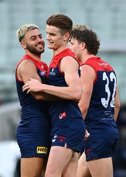 Bayley Fritsch of the Demons is congratulated by team mates after kicking a goal during the round 22 AFL match between Melbourne Demons and Adelaide...
