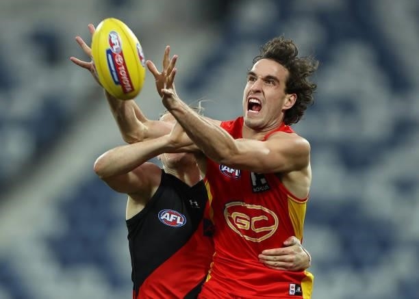 Ben King of the Suns is challenged by Mason Redman of the Bombers during the round 22 AFL match between Gold Coast Suns and Essendon Bombers at GMHBA...