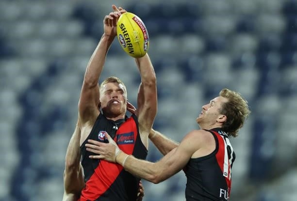 Peter Wright of the Bombers leaps for the ball during the round 22 AFL match between Gold Coast Suns and Essendon Bombers at GMHBA Stadium on August...