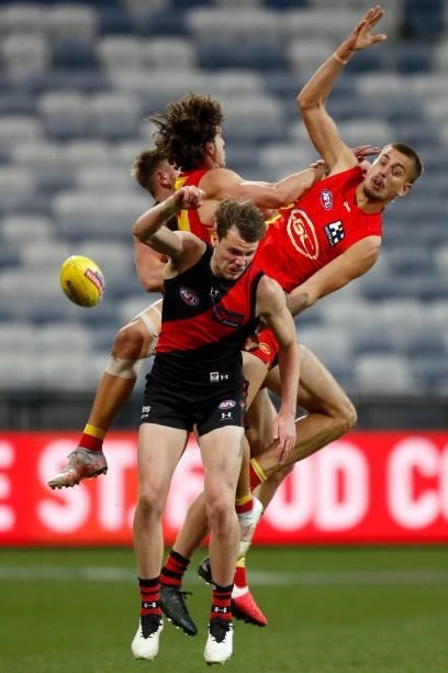 Ben King and Joel Jeffrey of the Suns compete in the air Jayden Laverde and Jordan Ridley of the Bombers with during the round 22 AFL match between...