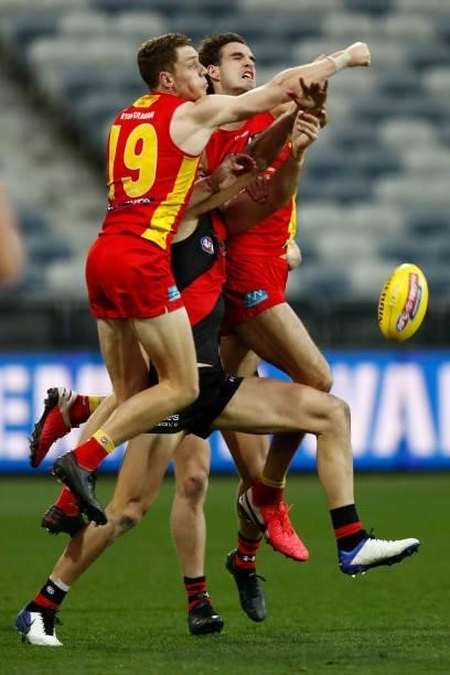 Josh Corbett of the Suns punches the ball during the round 22 AFL match between Gold Coast Suns and Essendon Bombers at GMHBA Stadium on August 15,...