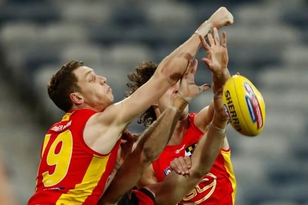 Josh Corbett of the Suns punches the ball during the round 22 AFL match between Gold Coast Suns and Essendon Bombers at GMHBA Stadium on August 15,...