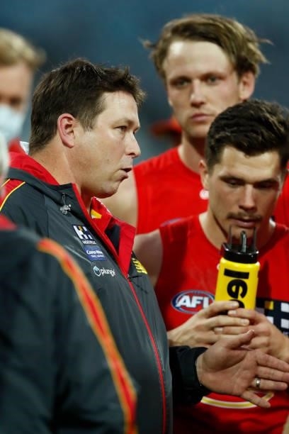 Stuart Dew, senior coach of the Suns speaks to his players during the round 22 AFL match between Gold Coast Suns and Essendon Bombers at GMHBA...