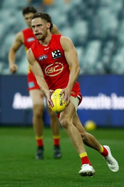 Jy Farrar of the Suns runs with the ball during the round 22 AFL match between Gold Coast Suns and Essendon Bombers at GMHBA Stadium on August 15,...
