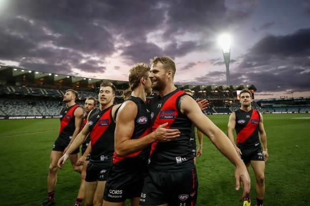 Darcy Parish and Jake Stringer of the Bombers embrace after the round 22 AFL match between Gold Coast Suns and Essendon Bombers at GMHBA Stadium on...