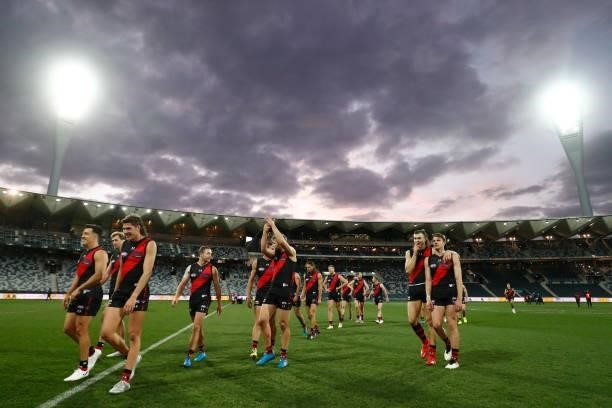 Essendon player celebrate their win after the round 22 AFL match between Gold Coast Suns and Essendon Bombers at GMHBA Stadium on August 15, 2021 in...