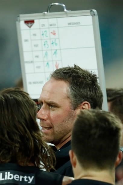 Ben Rutten, Senior Coach of the Bombers speaks to his players during the round 22 AFL match between Gold Coast Suns and Essendon Bombers at GMHBA...