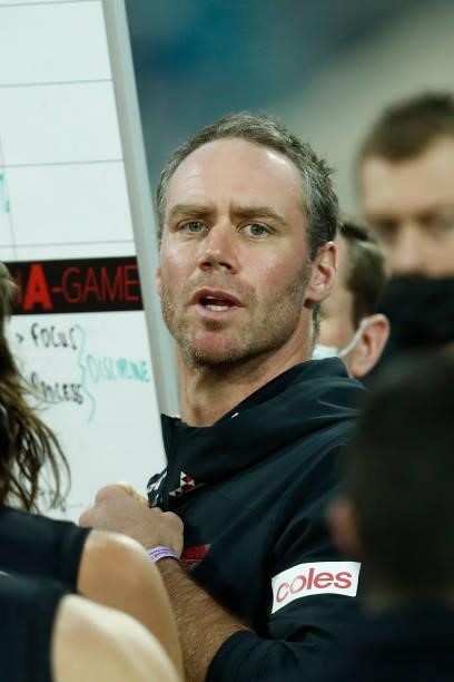Ben Rutten, Senior Coach of the Bombers speaks to his players during the round 22 AFL match between Gold Coast Suns and Essendon Bombers at GMHBA...