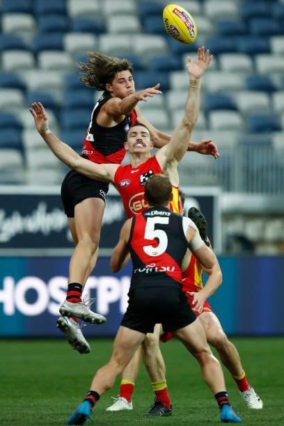 Sam Durham of the Bombers and Sam Collins of the Suns compete during the round 22 AFL match between Gold Coast Suns and Essendon Bombers at GMHBA...