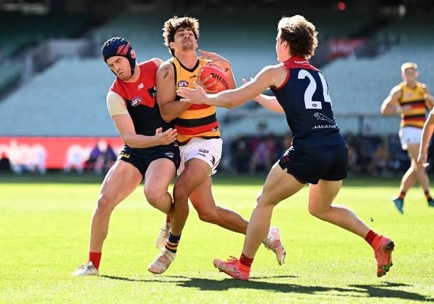 Shane McAdam of the Crows is tackled by Angus Brayshaw of the Demons during the round 22 AFL match between Melbourne Demons and Adelaide Crows at...