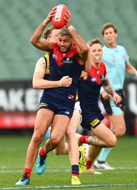 Christian Salem of the Demons is tackled during the round 22 AFL match between Melbourne Demons and Adelaide Crows at Melbourne Cricket Ground on...