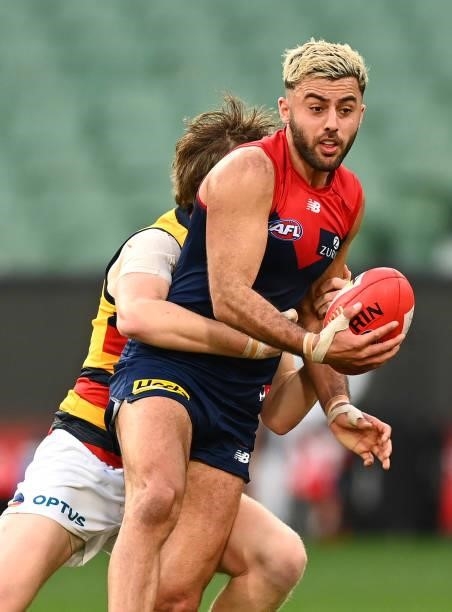 Christian Salem of the Demons is tackled during the round 22 AFL match between Melbourne Demons and Adelaide Crows at Melbourne Cricket Ground on...