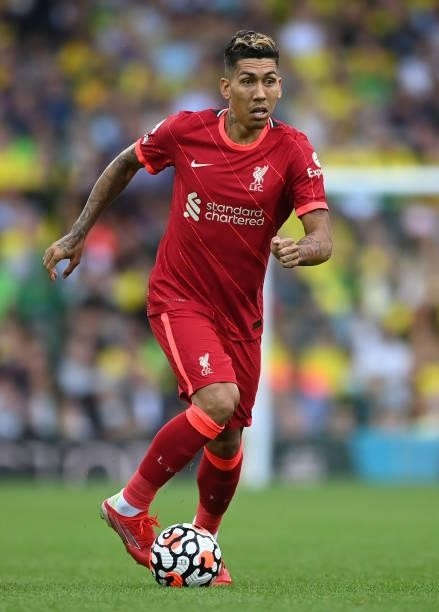 Roberto Firmino of Liverpool runs with the ball during the Premier League match between Norwich City and Liverpool at Carrow Road on August 14, 2021...