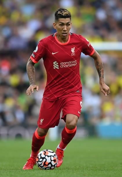 Roberto Firmino of Liverpool runs with the ball during the Premier League match between Norwich City and Liverpool at Carrow Road on August 14, 2021...