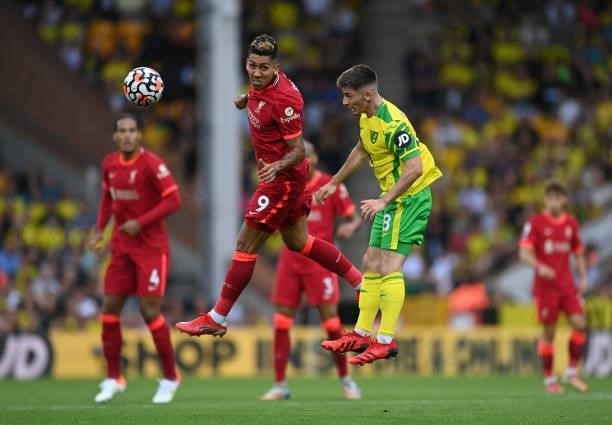 Roberto Firmino of Liverpool and Billy Gilmour of Norwich City challenge for the ball during the Premier League match between Norwich City and...