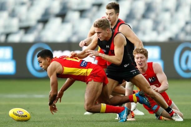 Touk Miller of the Suns chases the ball during the round 22 AFL match between Gold Coast Suns and Essendon Bombers at GMHBA Stadium on August 15,...