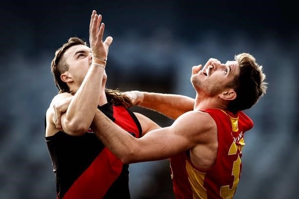 Sam Draper of the Bombers and Zac Smith of the Suns compete during the round 22 AFL match between Gold Coast Suns and Essendon Bombers at GMHBA...