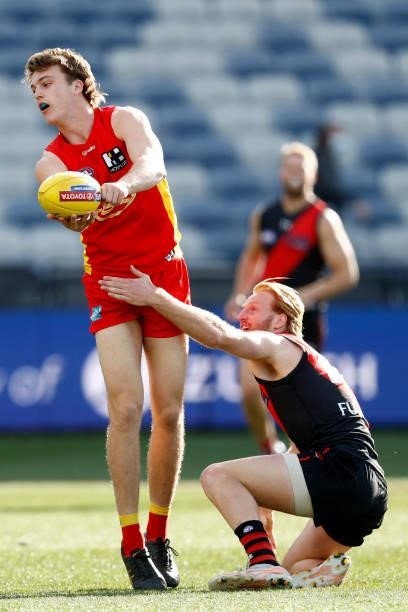 Charlie Ballard of the Suns handballs during the round 22 AFL match between Gold Coast Suns and Essendon Bombers at GMHBA Stadium on August 15, 2021...