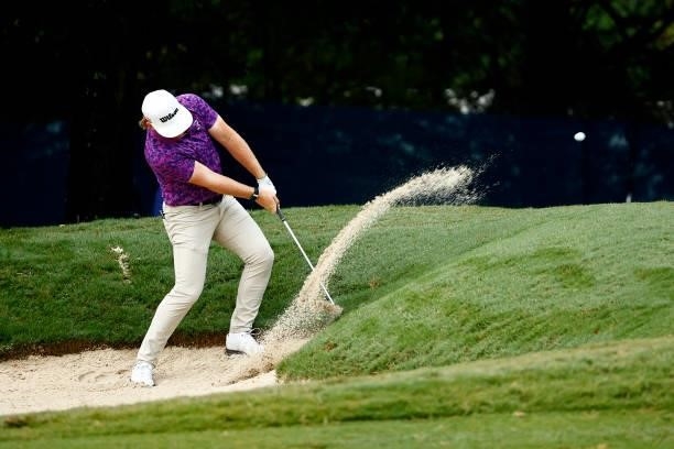 John Augenstein of the United States plays a shot from a bunker on the first hole during the final round of the Wyndham Championship at Sedgefield...