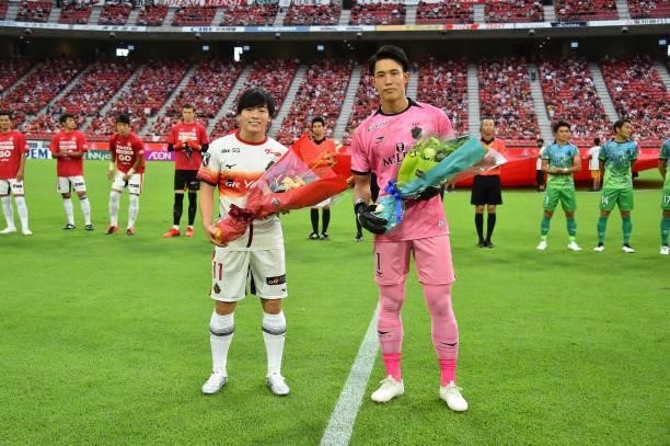 Yuki SOMA of Nagoya Grampus and Kosei TANI of Shonan Bellmare receive the flower bouquet prior to the J.League Meiji Yasuda J1 match between Nagoya...