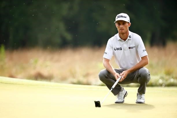 Will Zalatoris of the United States lines up a putt on the first green during the final round of the Wyndham Championship at Sedgefield Country Club...