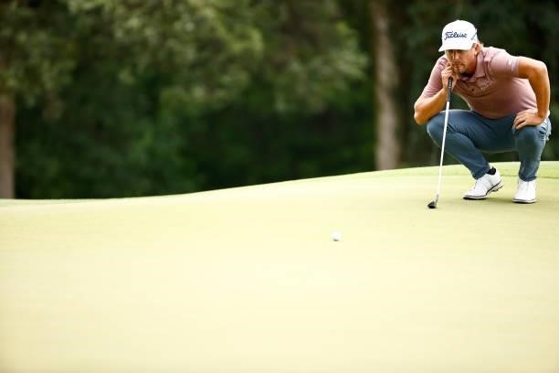 Roger Sloan of Canada lines up a putt on the first green during the final round of the Wyndham Championship at Sedgefield Country Club on August 15,...