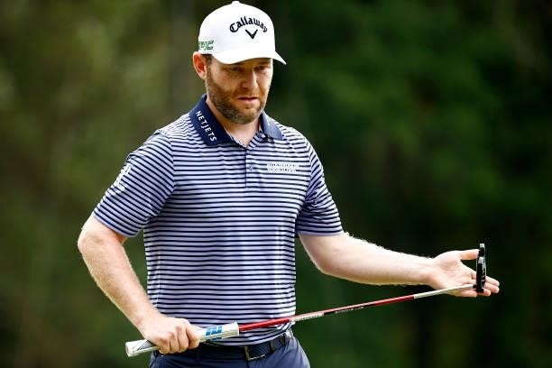 Branden Grace of South Africa reacts to his putt on the first green during the final round of the Wyndham Championship at Sedgefield Country Club on...