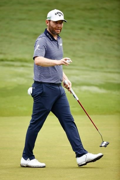 Branden Grace of South Africa waves on the second green during the final round of the Wyndham Championship at Sedgefield Country Club on August 15,...
