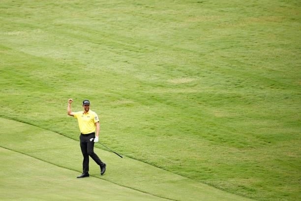 Webb Simpson of the United States celebrates holing out from the 11th fairway during the final round of the Wyndham Championship at Sedgefield...