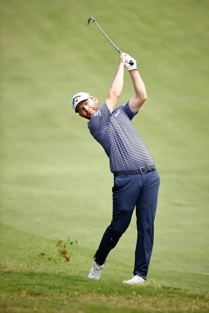 Branden Grace of South Africa plays an approach shot on the 11th hole during the final round of the Wyndham Championship at Sedgefield Country Club...