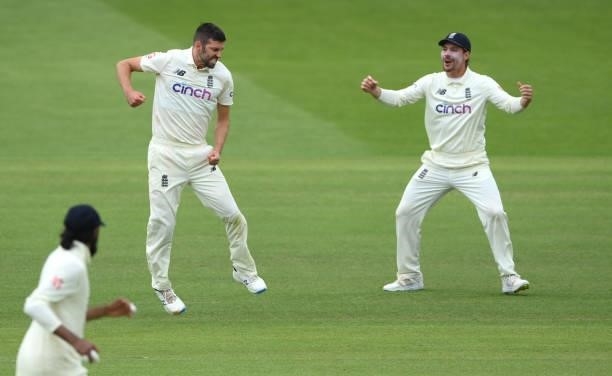 England bowler Mark Wood celebrates with Rory Burns after dismissing Punjara during day four of the Second Test Match between England and India at...