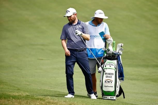 Branden Grace of South Africa pulls a club on the 11th fairway during the final round of the Wyndham Championship at Sedgefield Country Club on...