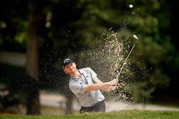 Tyler McCumber of the United States plays a shot from a bunker on the 11th hole during the final round of the Wyndham Championship at Sedgefield...