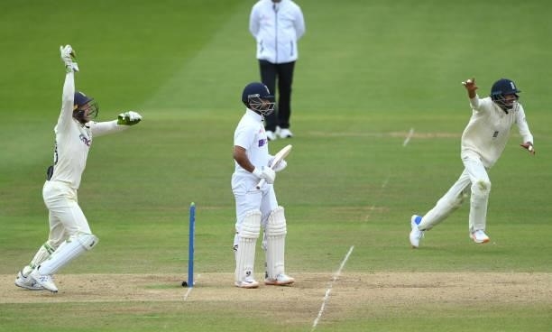 India batsman Ajinkya Rahane is caught by Jos Buttler off the bowling of Moeen Ali as Haseeb Hameed celebrates during day four of the Second Test...