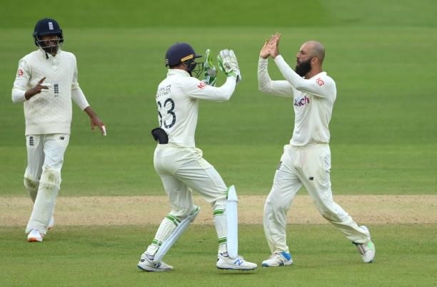 Moeen Ali celebrates with Jos Buttler after the pair had combined to dismiss India batsman Ajinkya Rahane during day four of the Second Test Match...