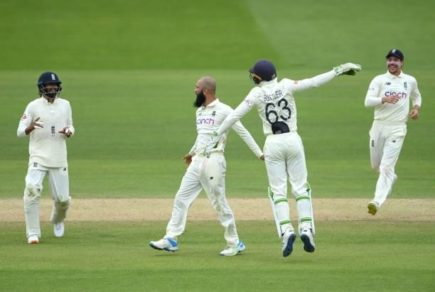 Moeen Ali celebrates with Jos Buttler after the pair had combined to dismiss India batsman Ajinkya Rahane during day four of the Second Test Match...