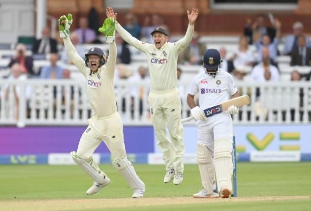 Jos Buttler and Joe Root of England celebrate after the dismissal of Ajinkya Rahane of India during the fourth day of the 2nd LV= Test match between...