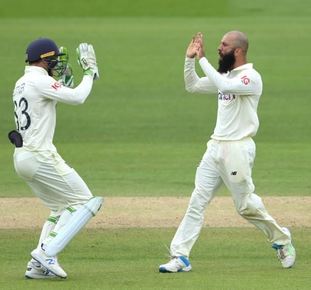England bowler Moeen Ali celebrates with Jos Buttler after the pair had combined to dismiss India batsman Ajinkya Rahane during day four of the...