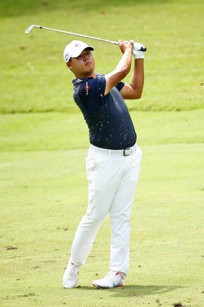 Si Woo Kim of South Korea plays an approach shot on the 17th hole during the final round of the Wyndham Championship at Sedgefield Country Club on...