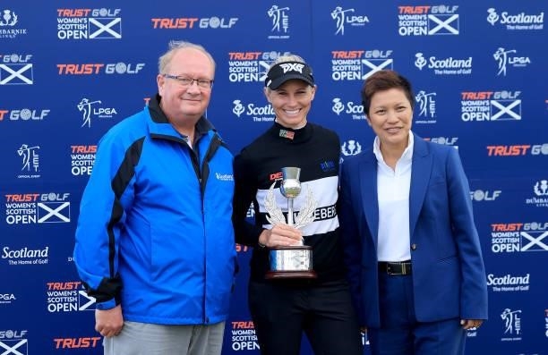 Ryann O'Toole of The United States poses with the trophy with Paul Bush director of VisitScotland and Dr Prin Singhanart the founder and CEO of Trust...
