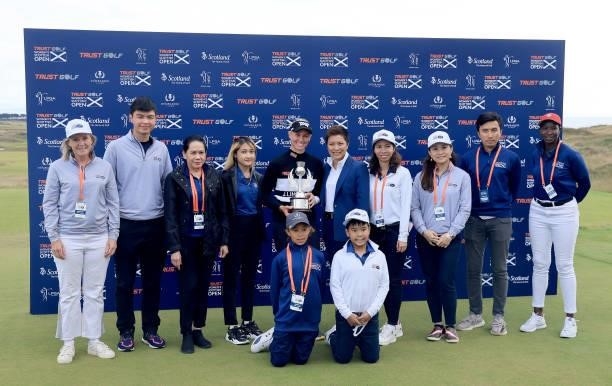 Ryann O'Toole of The United States poses with the trophy with Dr Prin Singhanart the founder and CEO of Trust Golf and other members of the Trust...