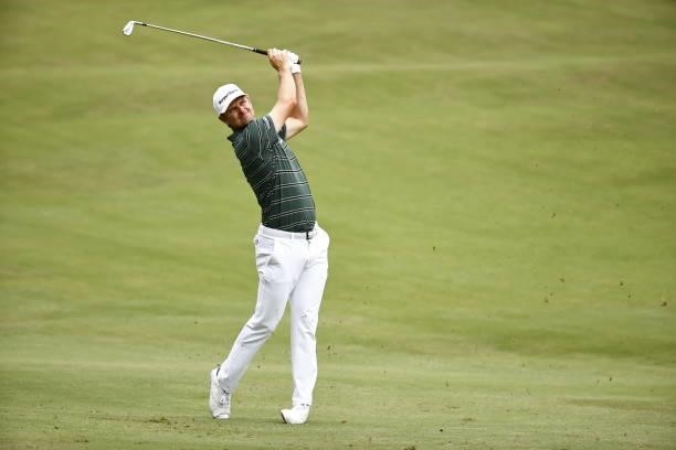 Justin Rose of England plays an approach shot on the 18th fairway during the final round of the Wyndham Championship at Sedgefield Country Club on...