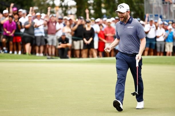 Branden Grace of South Africa celebrates his birdie putt on the 18th green during the final round of the Wyndham Championship at Sedgefield Country...